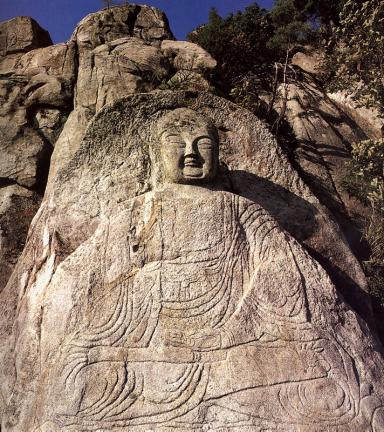 Seated buddhist statue carved on rook surface in Samneunggok