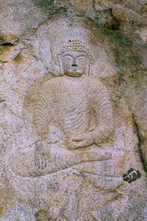 Seated buddha image carved on rock surface in Yongjangsa Temple site