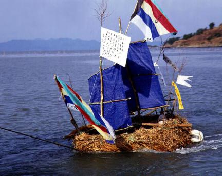 Straw ship for exorcism with flags